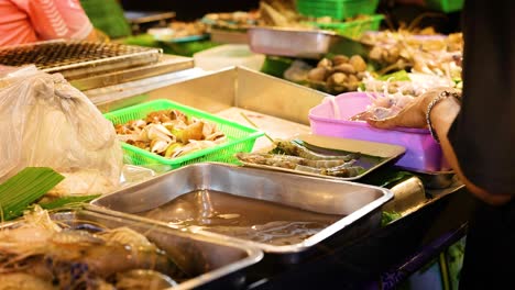 seafood preparation at bustling night market stall