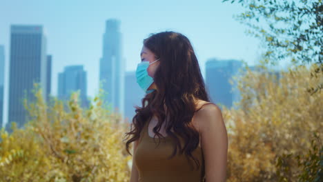 woman wearing medical mask outdoor closeup. asian girl cover face against covid