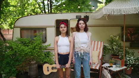 two friends enjoying a summer day in a camping trailer