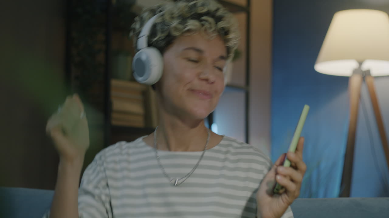 Woman Dancing and Enjoying Music at Home