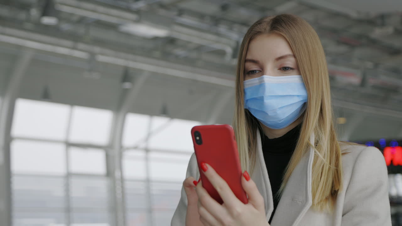 Woman Wearing Mask Using Phone at Airport