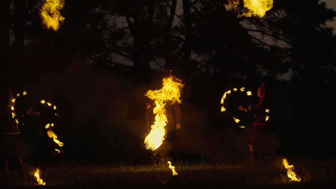 Fire Dancers in the Forest at Night