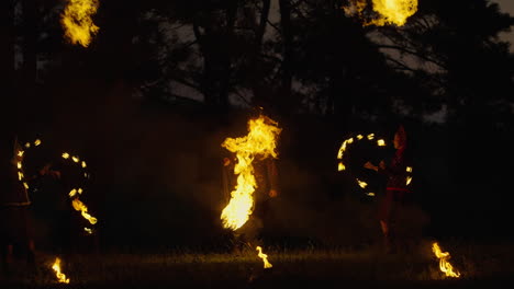 fire dancers in the forest at night