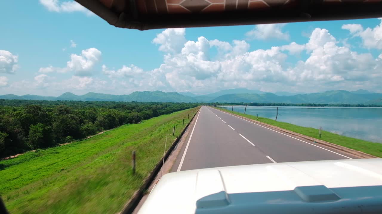 Long and green road into the Udawalawe National Park in Sri Lanka.