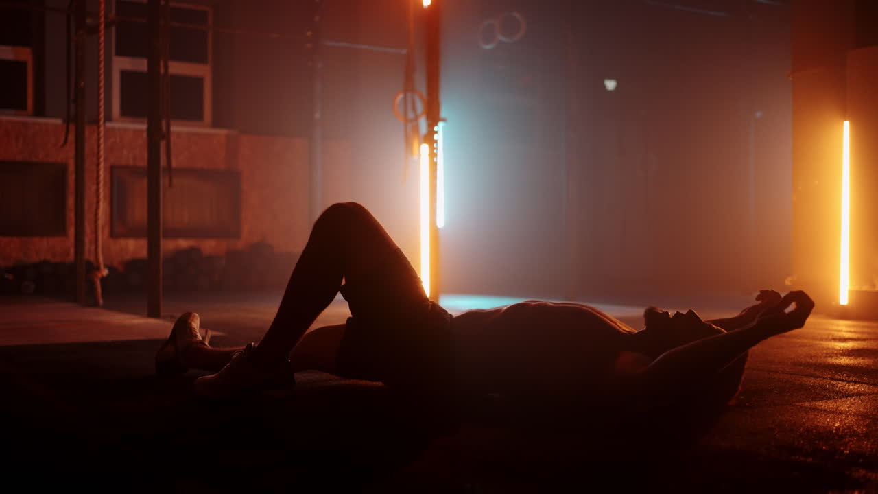 tired man in gym athlet is lying on floor and resting endurance and motivation