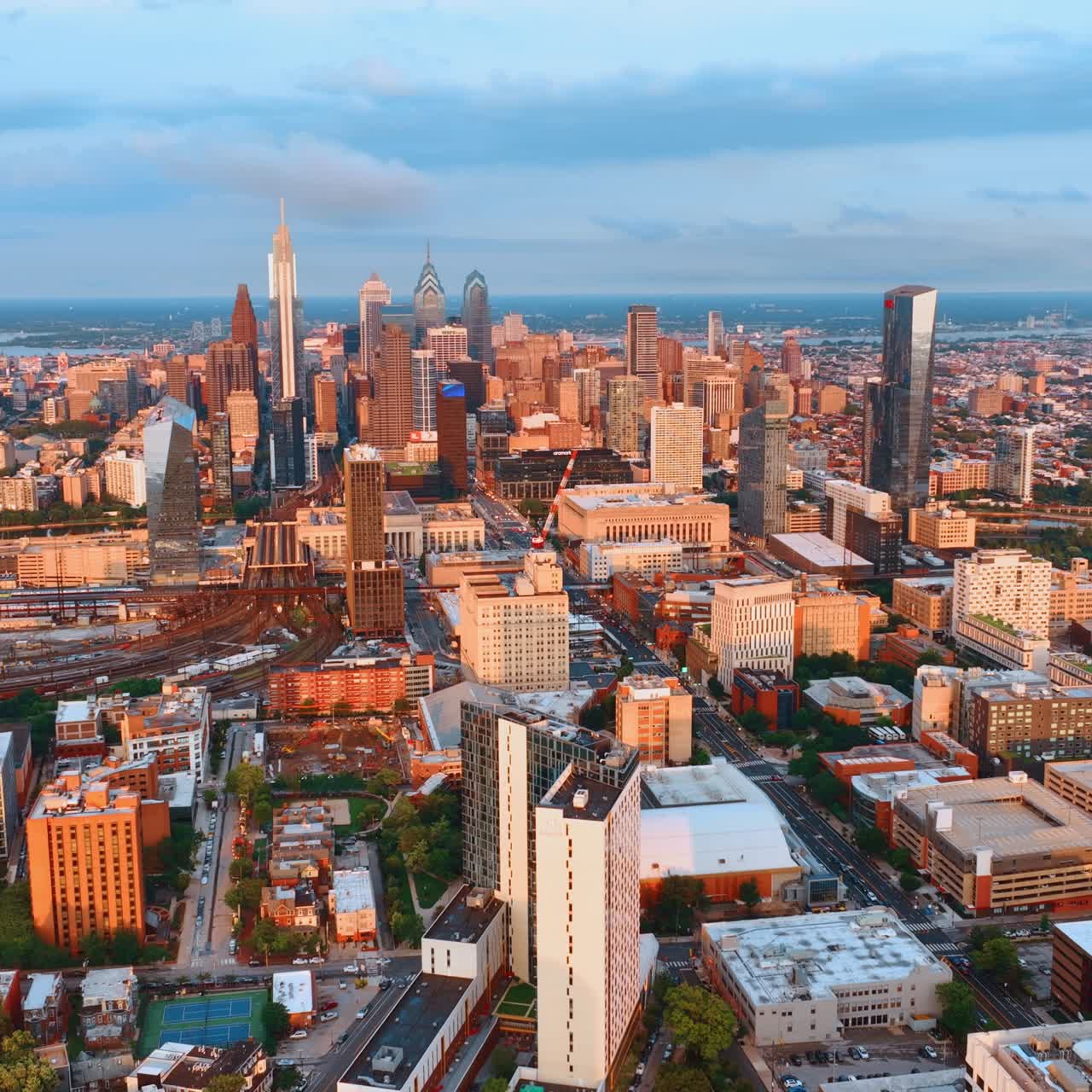 Stunning view of Philadelphia downtown at sunset. Drone footage approaching skyscraper complex of metropolis