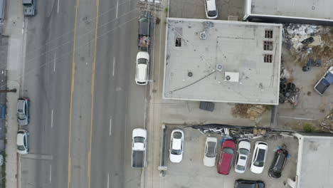 4k overhead drone shot of industrial area with cars, garbage and partial helicopter body