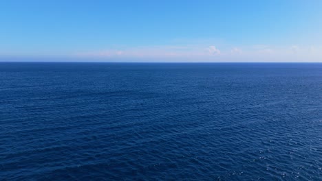 clear blue ocean water stretching to the horizon under soft light, a tranquil and open view