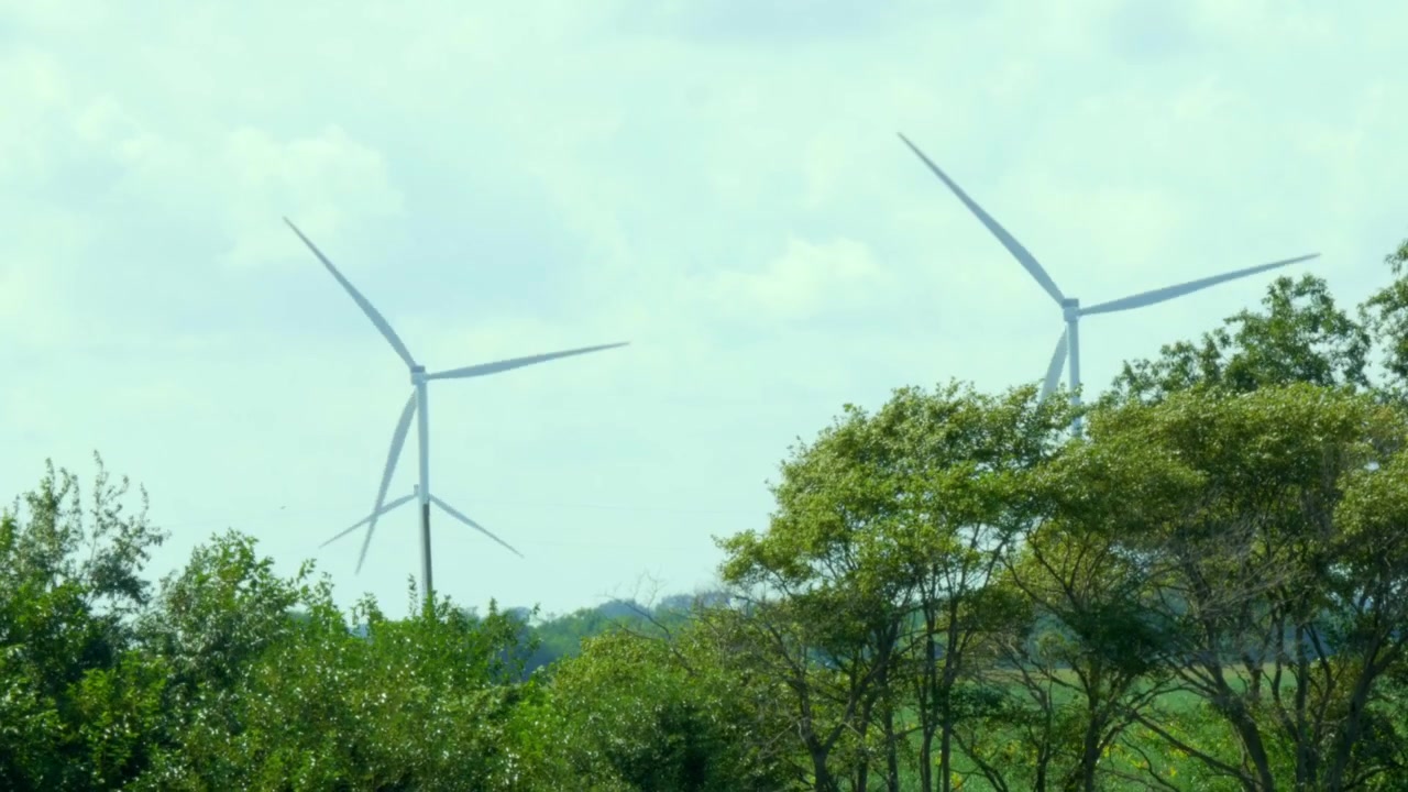 Drone shot of Meadow Lake Wind farm in North Central Indiana with wind turbines turning in the wind over a cornfield