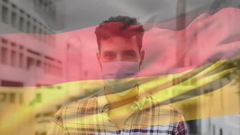 Animation-of-flag-of-germany-over-man-wearing-face-mask