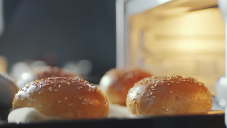 fresh hot buns on baking sheet