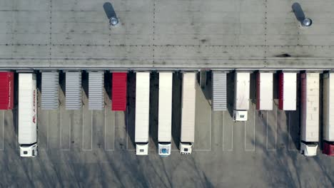 aerial shot of truck drives up at warehouse for loading or unloading. logistics, distribution center.