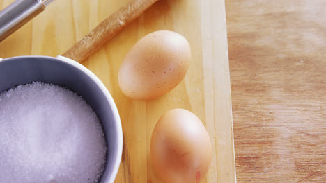 Various-ingredients-and-brown-egg-on-wooden-table-4k