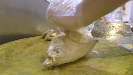 man chopping cooked duck with a butcher's knife in guangzhou, china - close up