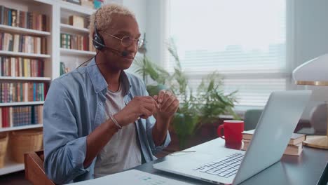 smiling customer support operator with handsfree headset working in the office