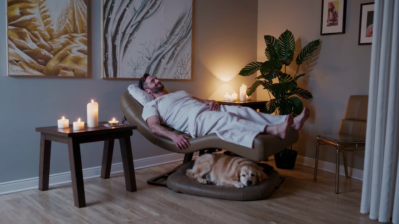 Man relaxing in a spa chair with his dog