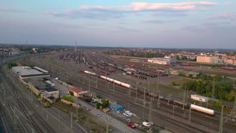 aerial view of a vast railway yard with numerous tracks and trains under a cloudy sky. amazing flight panorama overview drone