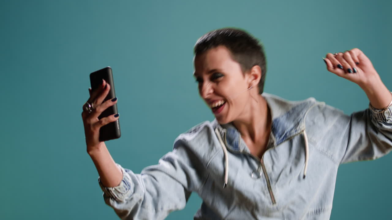 Woman taking selfies with her phone