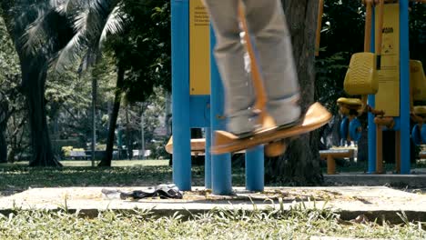 leg swing on outdoor fitness equipment