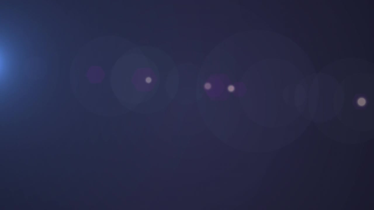 Animación de estelas de luz y manchas sobre fondo negro