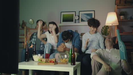 friends watching a game at home