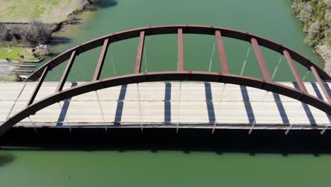 Aerial Austin Pennybacker Bridge - diagonal viewpoint of the bridge from above, moving towards the left very slowly. Very few cars crossing at the time, much fewer than usual.