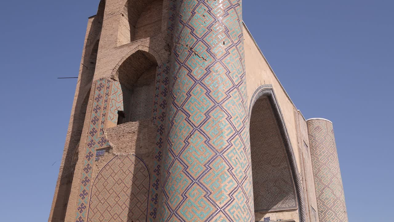 Tall minarets with historic intricate tiling of a madrassa in Samarkand, Uzbekistan along the historic Silk Road