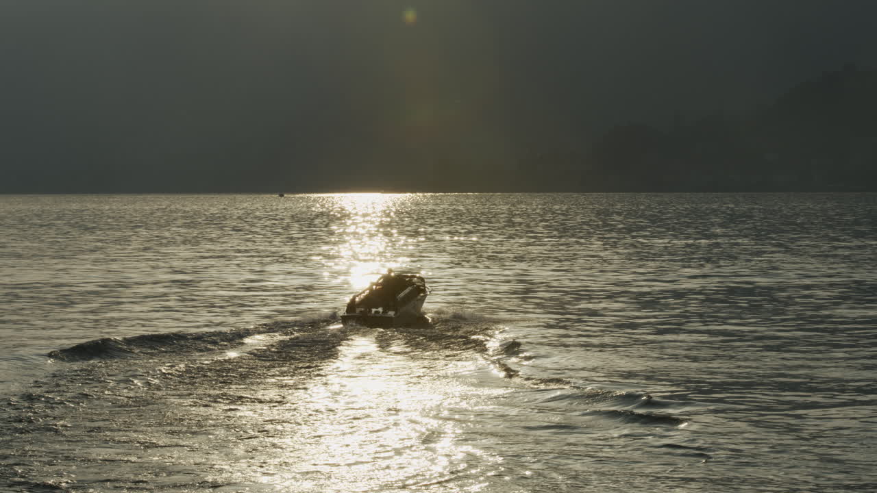 Luxury boat on Lake Como at sunset.