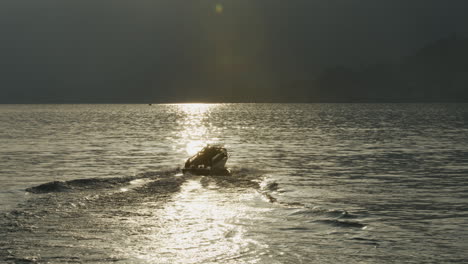 luxury boat on lake como at sunset.