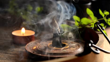 Incense-cone-and-candles-on-tray-with-teapot