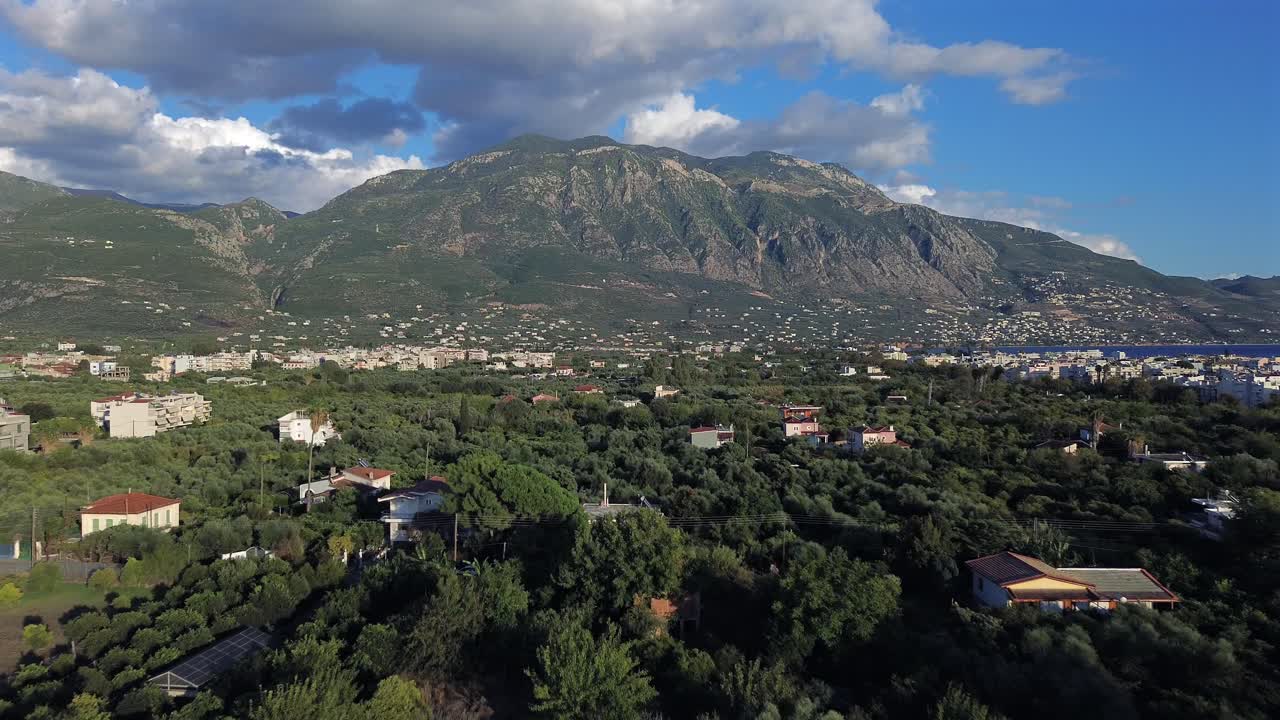 Aerial push in flying above olive tree orchards, revealing Taygetos mountain, Kalamata, Messinia, Peloponnese , Greece 4K