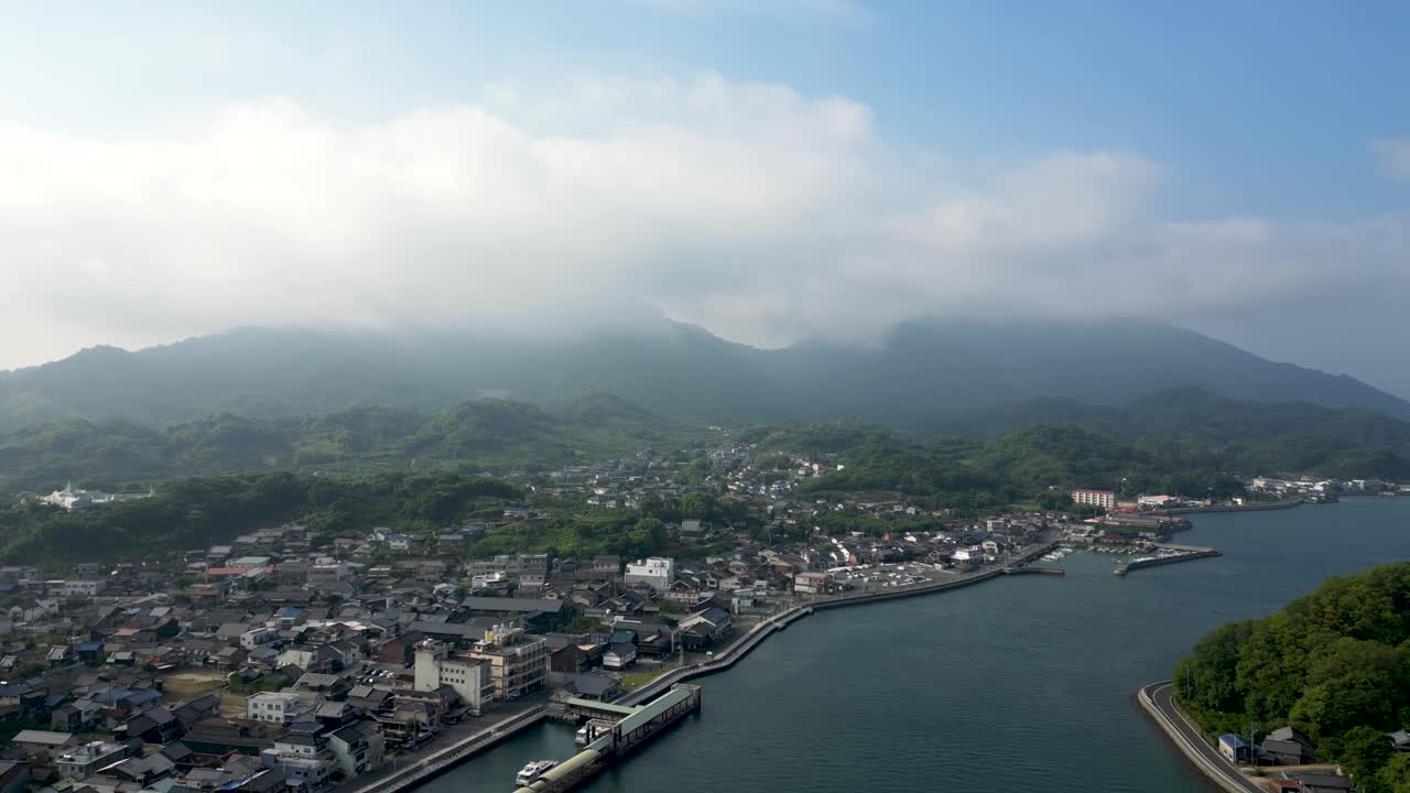 Slow rotating shot over Seto Inland Sea islands with small port village