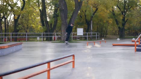 Extreme-skateboarder-grinding-down-rail,-almost-falls-but-jumps-on-his-feet.-Slow-Motion-shot