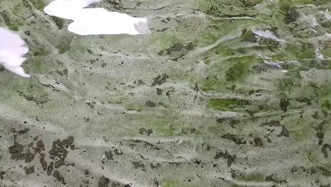 Close-up-view-of-tank-ground,-moving-water-causing-reflection