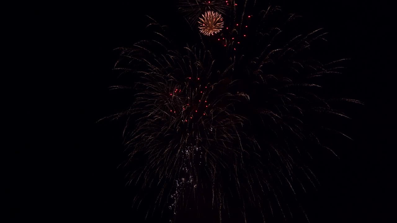 Fireworks light up the sky with dazzling display. Abstract colored firework background with free space for text. 4k.