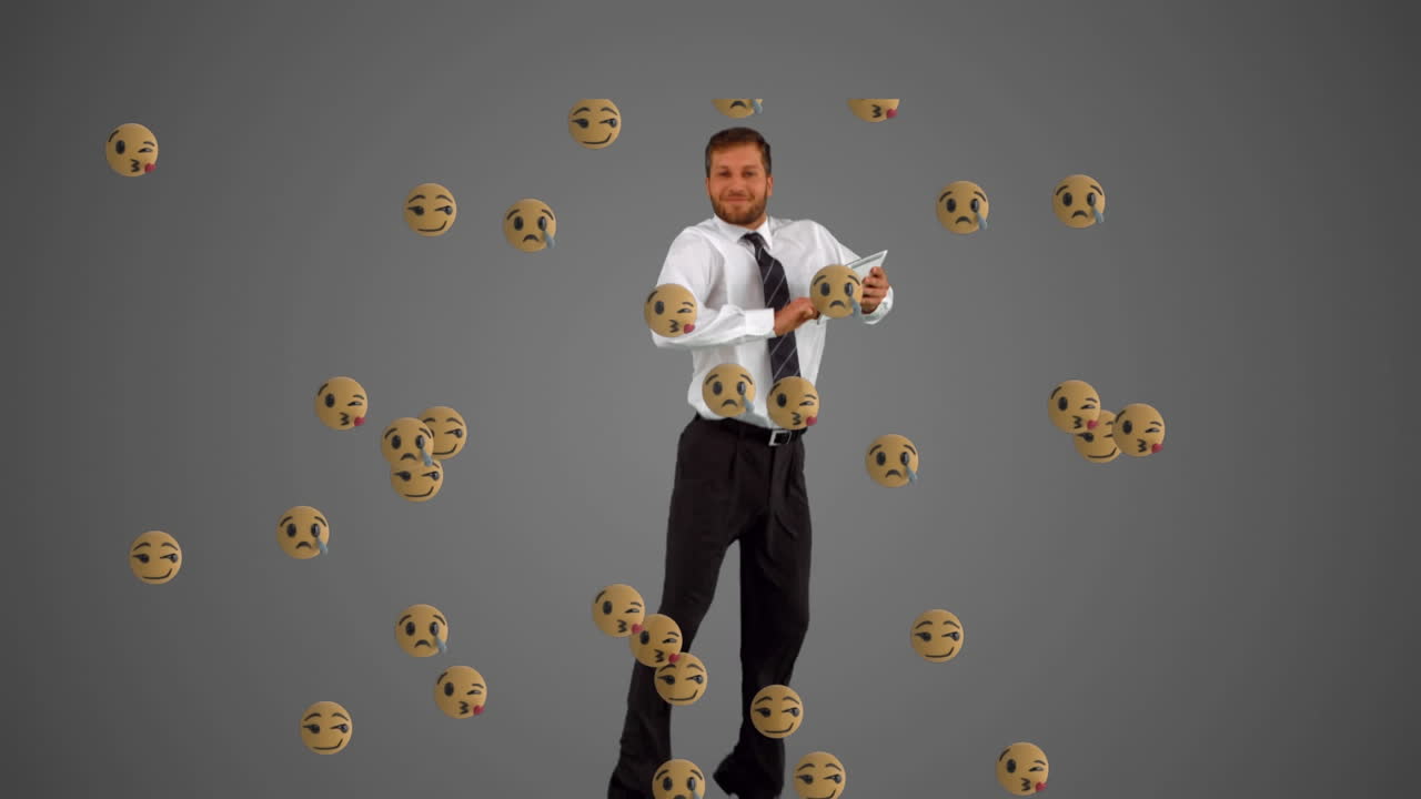 Animation of emoji icons over caucasian businessman using tablet