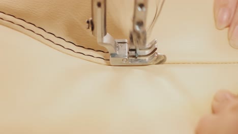 closeup of sewing machine working part with leather. cnc sewing machine