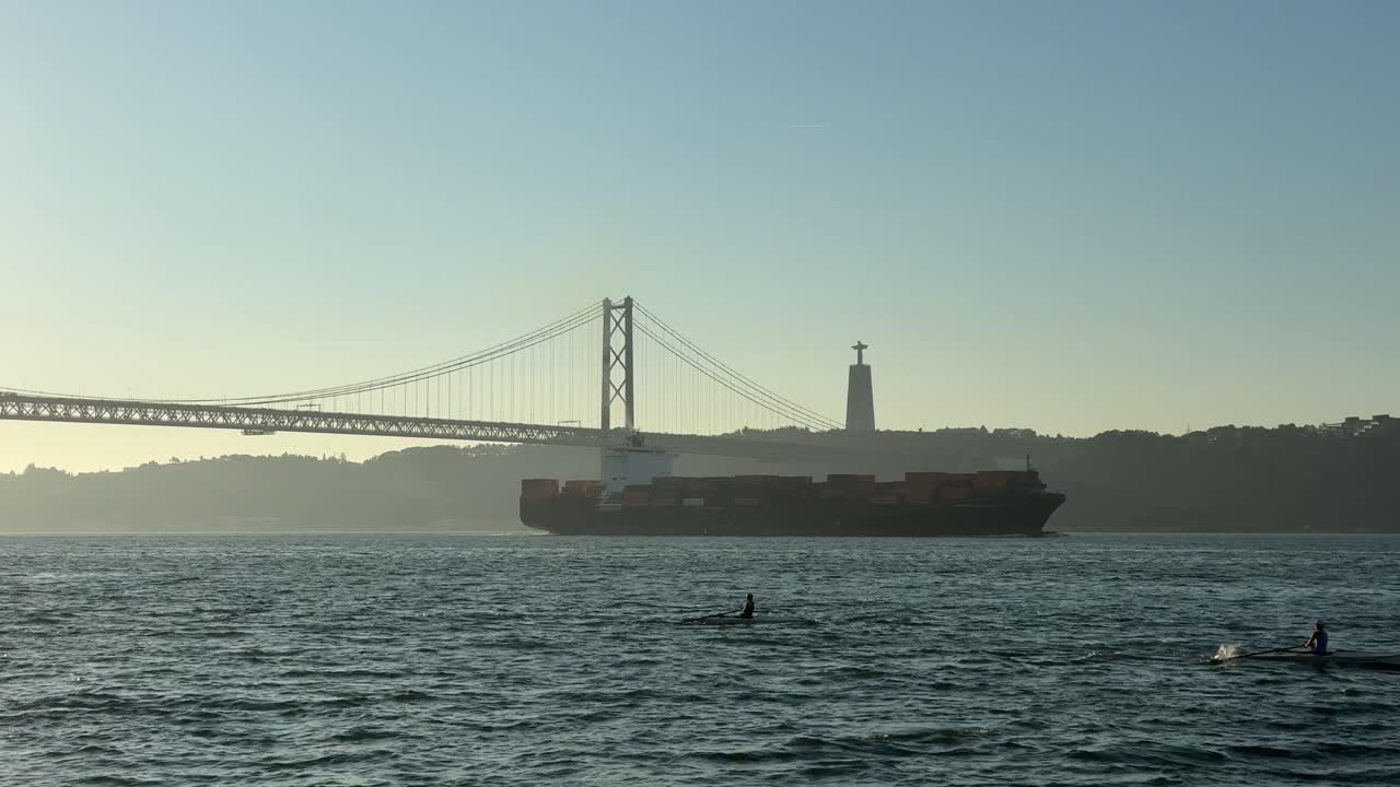 View of Ponte 25 de Abril, cargo ship, Christ the King statue and kayaks