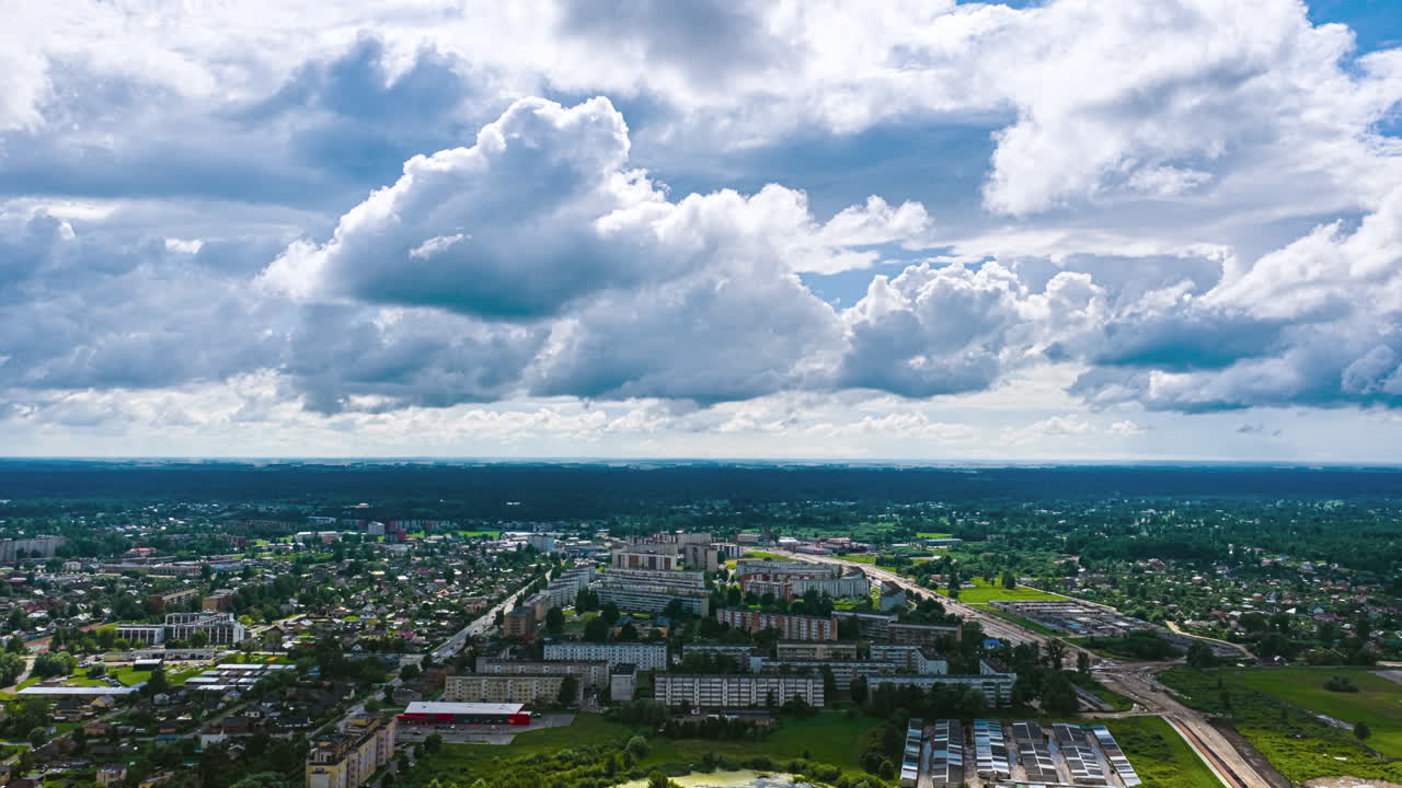 Aerial timelapse of a European city under fast-moving dramatic clouds, showing urban streets, rooftops, and shifting weather patterns