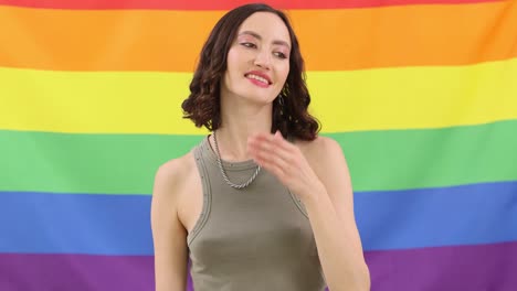 Woman Blowing Kisses in Front of Rainbow Pride Flag