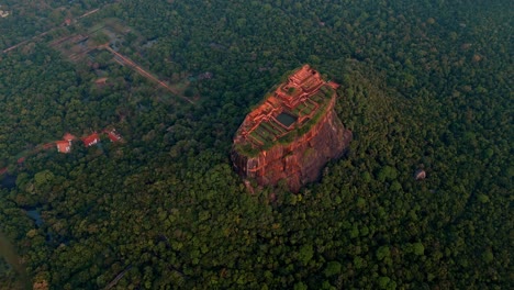 cinematic aerial drone clip flying over the majestic sigiriya rock at sunrise in central sri lanka.