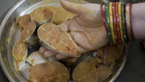 fresh fish marinating in spices at home in plat from different angle