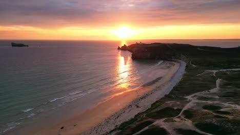 Linear-Aerial-of-Sun-Setting-Over-Ocean-and-Beach