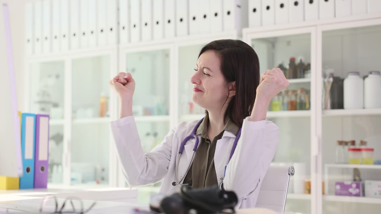 Excited Doctor Celebrating Success in Office