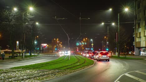 Timelapse-of-city-rush-hour-traffic-on-the-street-of-Liepaja-tram-bridge,-traffic-light-streaks,-tram-rails-with-fast-moving-trams,-wide-shot