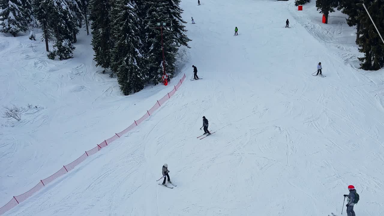 Skiers enjoy a winter day on the slopes in the Carpathians in Bulgaria