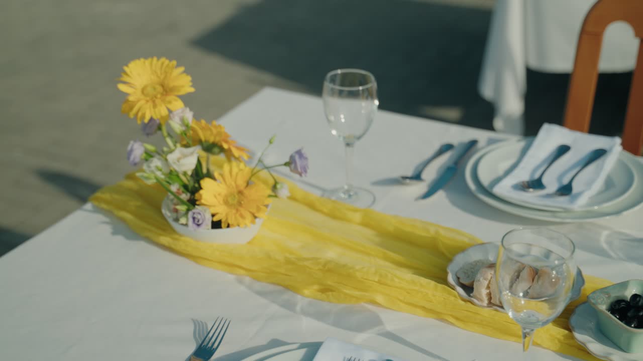 bright floral table decor and bread served for outdoor meal