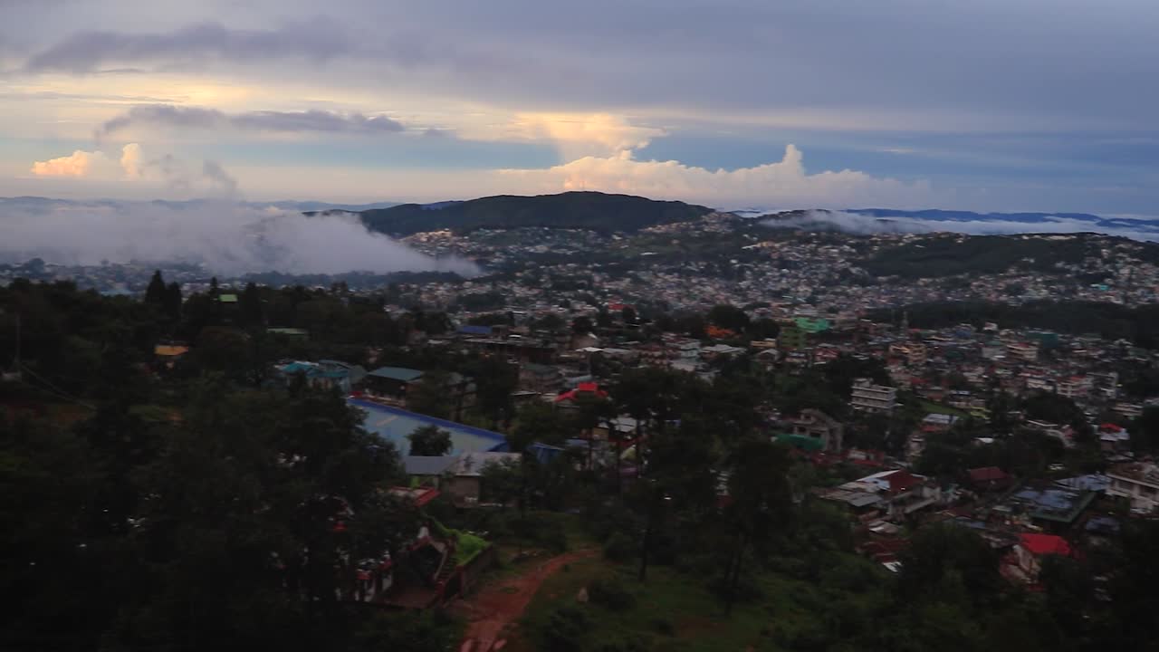 downtown city view with dramatic cloudy sky at evening from mountain top video is taken at shillong meghalaya india