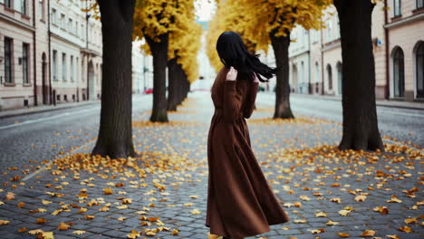 woman walking on a cobblestone street in autumn