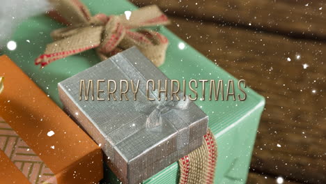 Animation-of-merry-christmas-text-over-snow-falling-with-christmas-presents